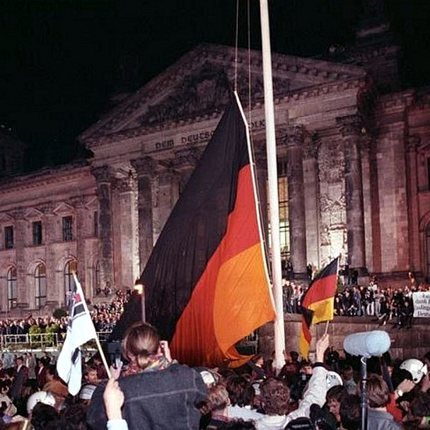 Feier der Wiedervereinigung 1990 in Berlin Hunderttausende waren am 3. Oktober 1990 dabei, als vor dem Reichstags-Gebäude in Berlin die deutsche Wiedervereinigung gefeiert wurde. Unser Foto zeigt , wie dort an dem Tag die schwarz-rot-goldene Bundesfahne gehißt wurde.